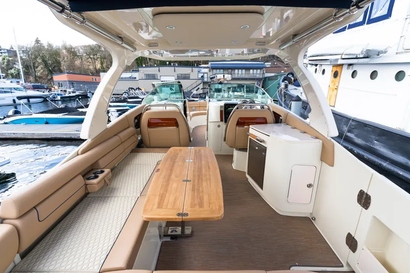Slide: The Image of Luxurious 2025 Chris-Craft Launch 35 GT boat interior with elegant seating and wooden table. - 11