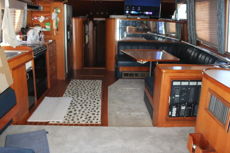 Slide: The Image of Interior of a 1994 Mikelson 64 yacht with wood finishes and modern amenities. - 10