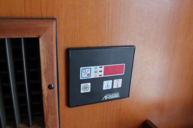 Slide: The Image of Control panel on a 1994 Mikelson 64 yacht, featuring temperature and fan settings. - 18