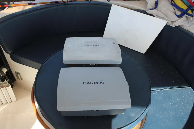 Slide: The Image of Two Garmin devices on a table inside a 1994 Mikelson 64 yacht. - 21