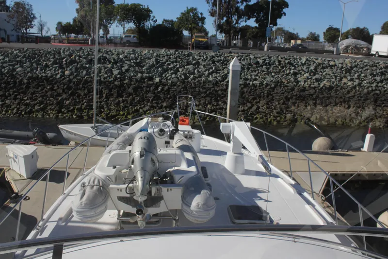 Slide: The Image of Bow view of 1994 Mikelson 64 yacht docked at marina. - 23