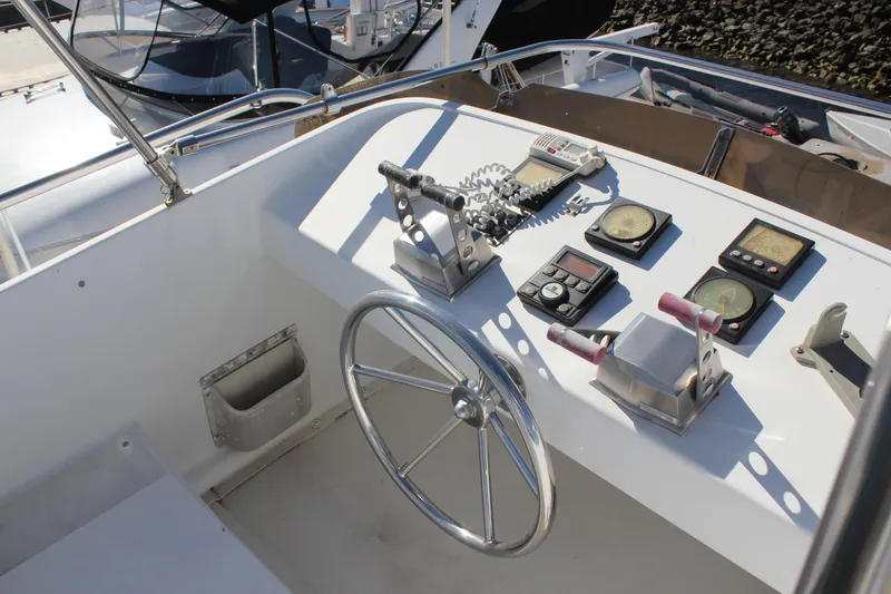 Slide: The Image of Control panel of a 1994 Mikelson 64 yacht with steering wheel and navigation instruments. - 26