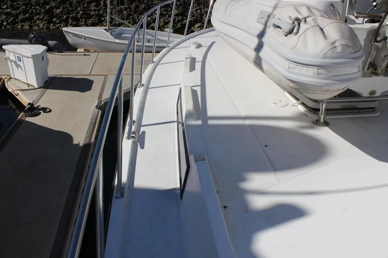 Slide: The Image of 1994 Mikelson 64 yacht deck with railing and inflatable boat. - 28