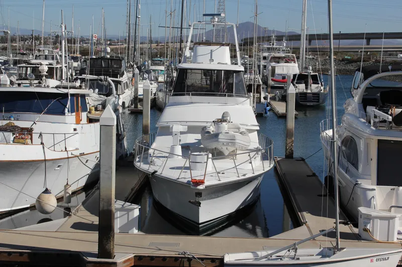 Slide: The Image of Mikelson 64 yacht from 1994 docked at a marina, surrounded by other boats. - 31