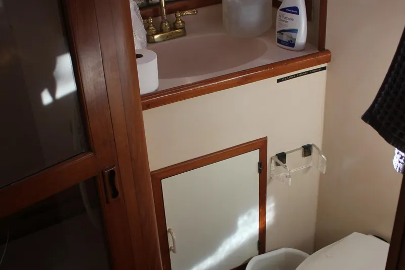 Slide: The Image of Bathroom interior of a 1994 Mikelson 64 yacht with wooden cabinetry and sink. - 34