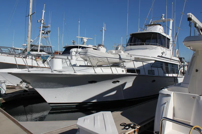 Slide: The Image of 1994 Mikelson 64 yacht docked at marina under clear blue sky. - 4