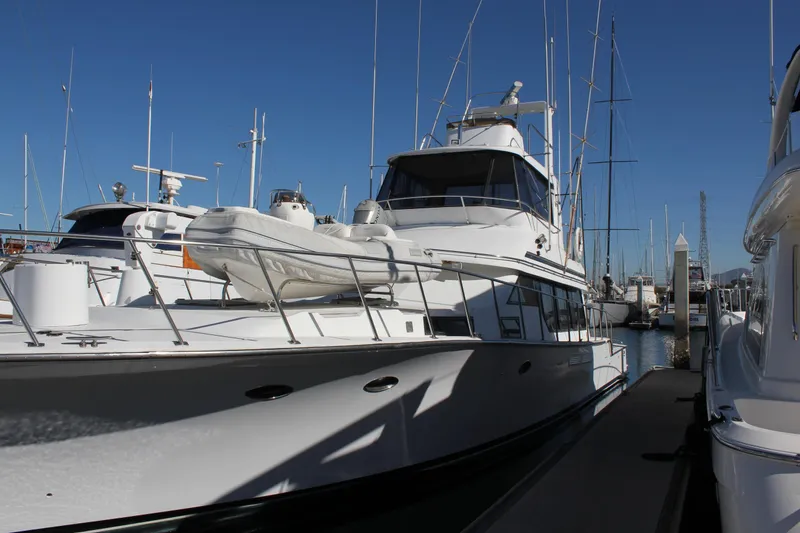 Slide: The Image of 1994 Mikelson 64 yacht docked at marina under clear blue sky. - 5