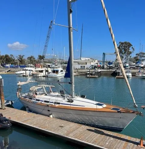 The Image of Bavaria 42 Cruiser 2000 docked at marina under clear blue sky. - 0