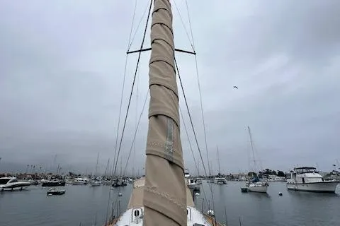 Slide: The Image of Bavaria 42 Cruiser 2000 sailboat in a marina, overcast sky, wrapped mast. - 10