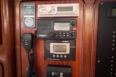 Slide: The Image of Control panel of a 2000 Bavaria 42 Cruiser yacht with navigation and communication equipment. - 24