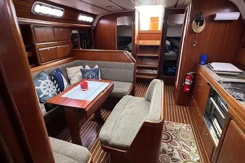 Slide: The Image of Interior of 2000 Bavaria 42 Cruiser yacht with cozy seating and wooden finishes. - 28