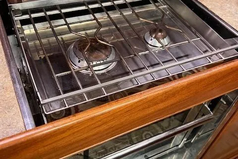 Slide: The Image of Stove inside Bavaria 42 Cruiser yacht, 2000 model, featuring two burners and wooden cabinetry. - 29
