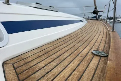 Slide: The Image of Bavaria 42 Cruiser 2000 sailboat with teak deck and blue stripe detail. - 3