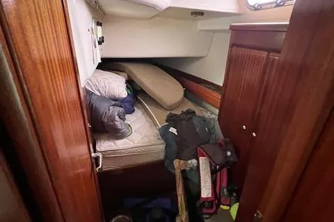 Slide: The Image of Cabin interior of 2000 Bavaria 42 Cruiser with bedding and storage items. - 31