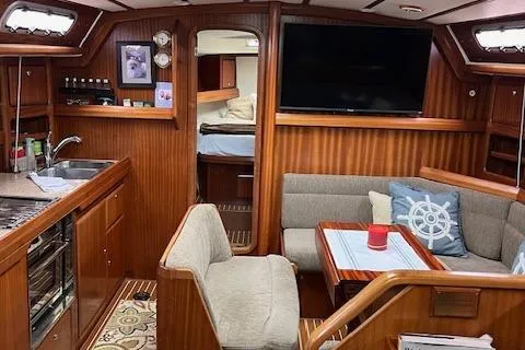 Slide: The Image of Interior of 2000 Bavaria 42 Cruiser yacht with cozy seating and modern amenities. - 36