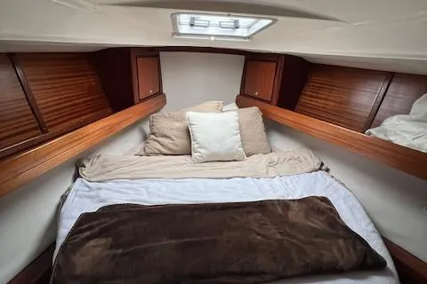 Slide: The Image of Cozy cabin interior of 2000 Bavaria 42 Cruiser with wooden accents and comfortable bedding. - 39