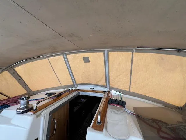 Slide: The Image of Interior view of a 2000 Bavaria 42 Cruiser sailboat cockpit under cover. - 43