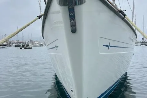 Slide: The Image of Bavaria 42 Cruiser 2000 yacht bow in marina, calm water, overcast sky. - 5
