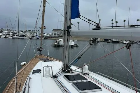 Slide: The Image of Bavaria 42 Cruiser 2000 sailboat docked in a marina, overcast sky. - 9