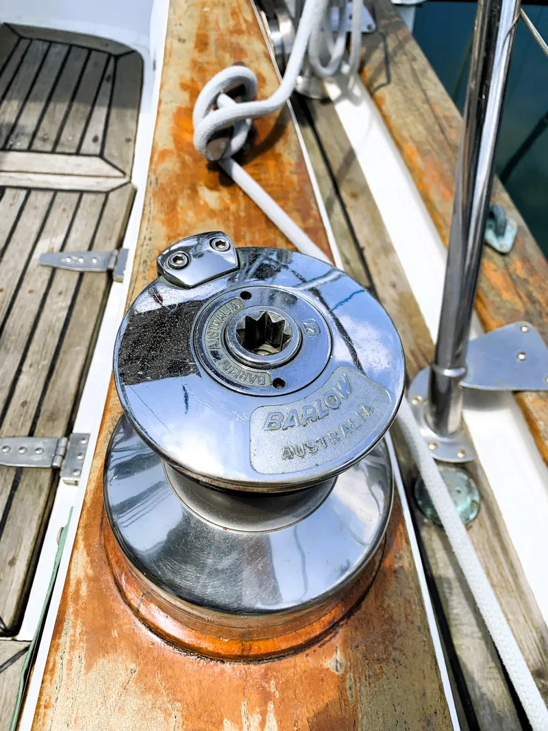 Slide: The Image of Winch on 1979 Robert Perry 41 Sloop, featuring polished metal and wooden deck. - 20