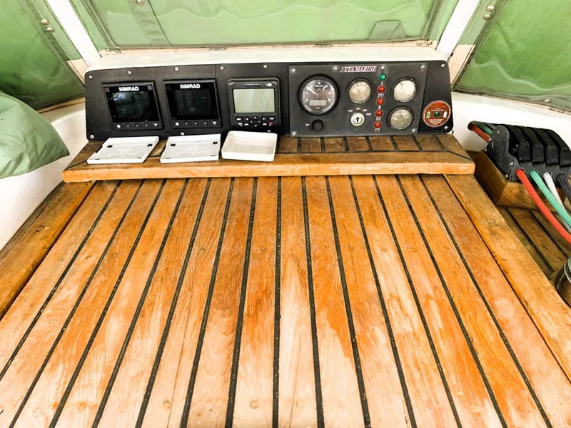 Slide: The Image of Wooden cockpit of 1979 Robert Perry 41 Sloop with navigation instruments and controls. - 23