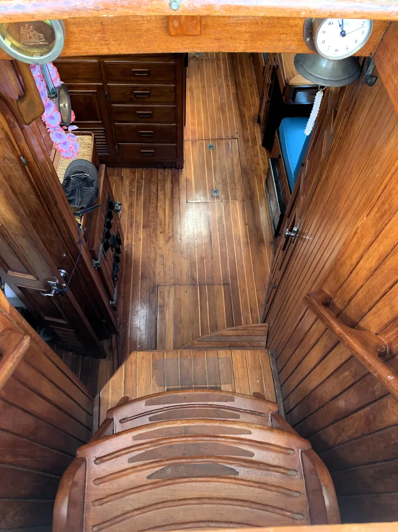 Slide: The Image of Interior of 1979 Robert Perry 41 Sloop, featuring wooden flooring and cabinetry. - 28