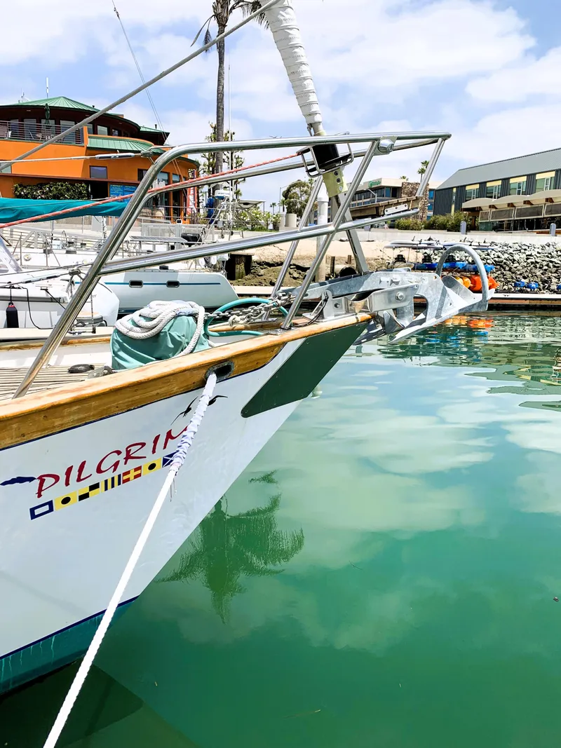 Slide: The Image of 1979 Robert Perry 41 Sloop docked in marina, calm water, clear sky. - 4