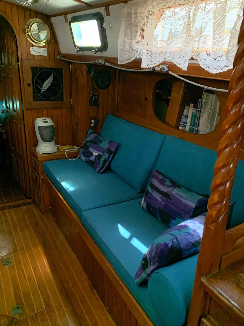 Slide: The Image of Interior of 1979 Robert Perry 41 Sloop with blue seating and wooden accents. - 45
