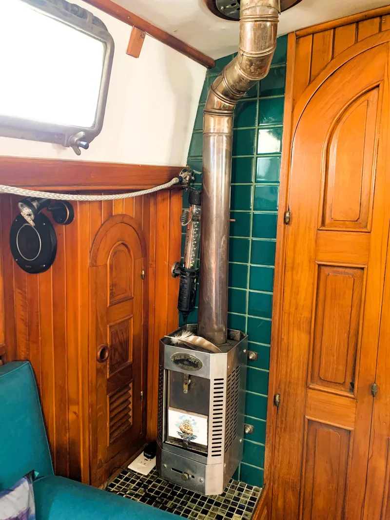 Slide: The Image of Wood-paneled cabin interior of 1979 Robert Perry 41 Sloop with stove and teal tiles. - 47