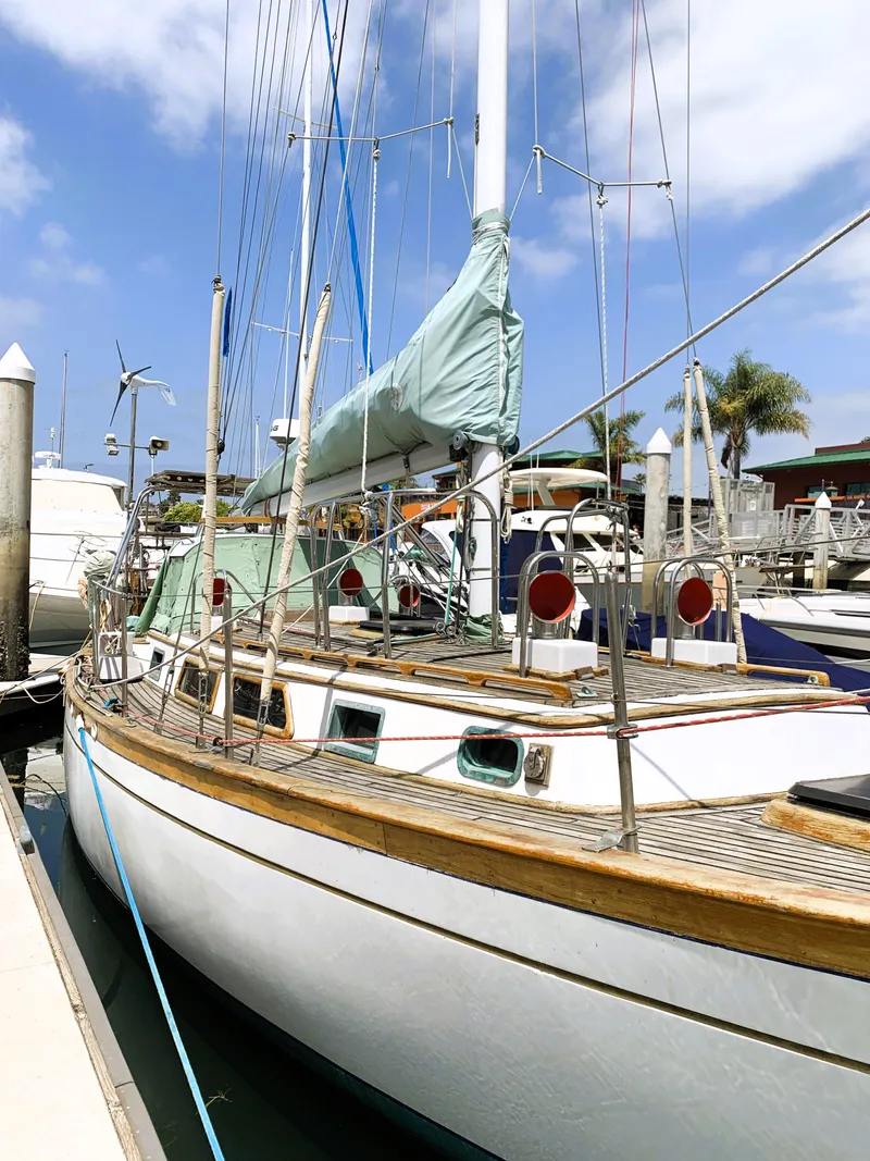 Slide: The Image of 1979 Robert Perry 41 Sloop docked at marina under blue sky. - 5