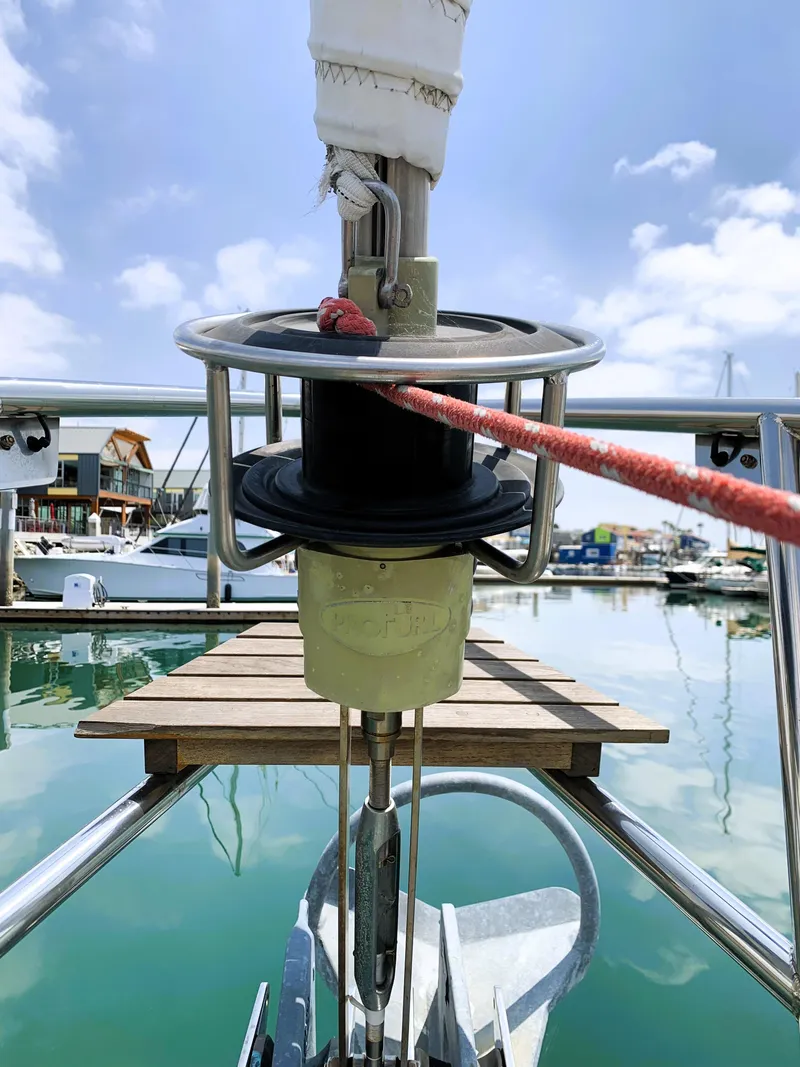 Slide: The Image of Foredeck view of 1979 Robert Perry 41 Sloop in marina, featuring anchor and winch. - 7