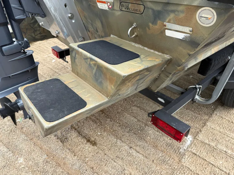 Slide: The Image of 2017 Tracker Grizzly 1654 MVX Sportsman boat steps with anti-slip pads and trailer lights. - 10