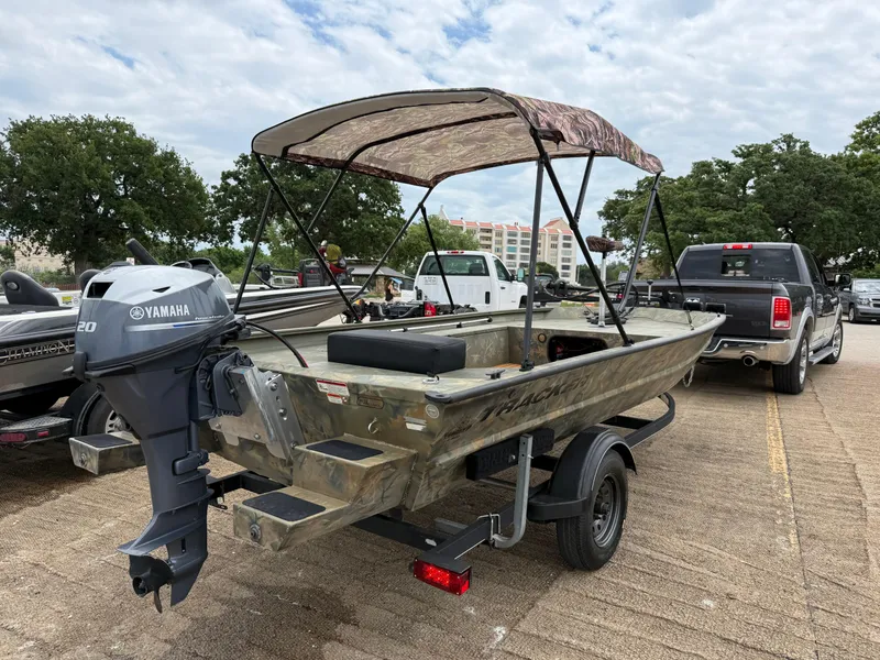 Slide: The Image of 2017 Tracker Grizzly 1654 MVX Sportsman boat with Yamaha motor, parked on trailer. - 28