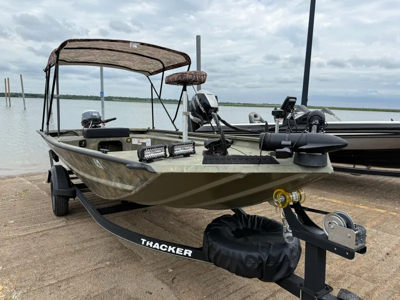 Slide: The Image of 2017 Tracker Grizzly 1654 MVX Sportsman boat on trailer by the lake. - 36