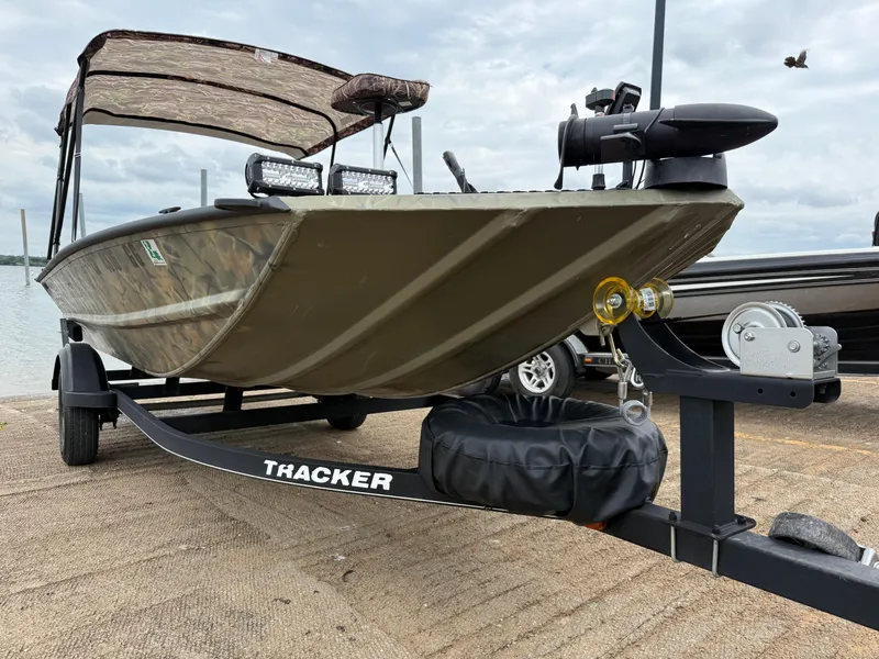 Slide: The Image of 2017 Tracker Grizzly 1654 MVX Sportsman boat on trailer at dockside. - 37