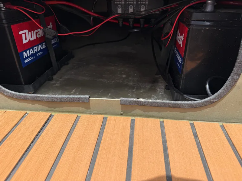 Slide: The Image of 2017 Tracker Grizzly 1654 MVX Sportsman boat battery compartment with marine batteries and wiring. - 39