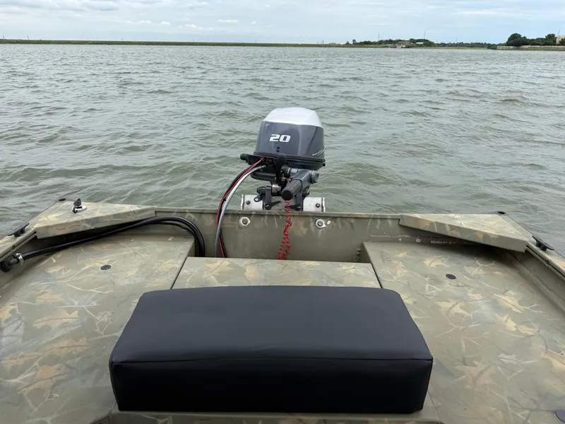 Slide: The Image of 2017 Tracker Grizzly 1654 MVX Sportsman boat on water, featuring a 20 HP outboard motor. - 44