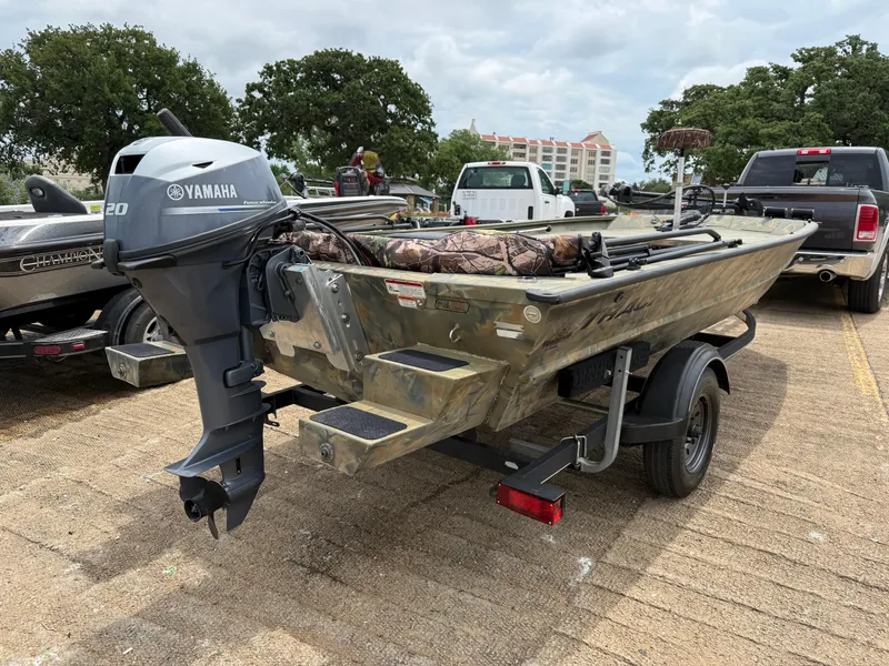 Slide: The Image of 2017 Tracker Grizzly 1654 MVX Sportsman boat with Yamaha motor on trailer in parking lot. - 6