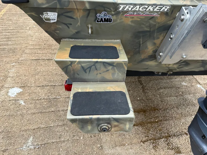 Slide: The Image of 2017 Tracker Grizzly 1654 MVX Sportsman boat with camo design and step platform. - 8