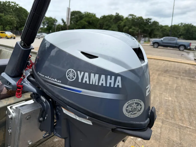 Slide: The Image of Yamaha outboard motor on 2017 Tracker Grizzly 1654 MVX Sportsman boat, parked outdoors. - 9