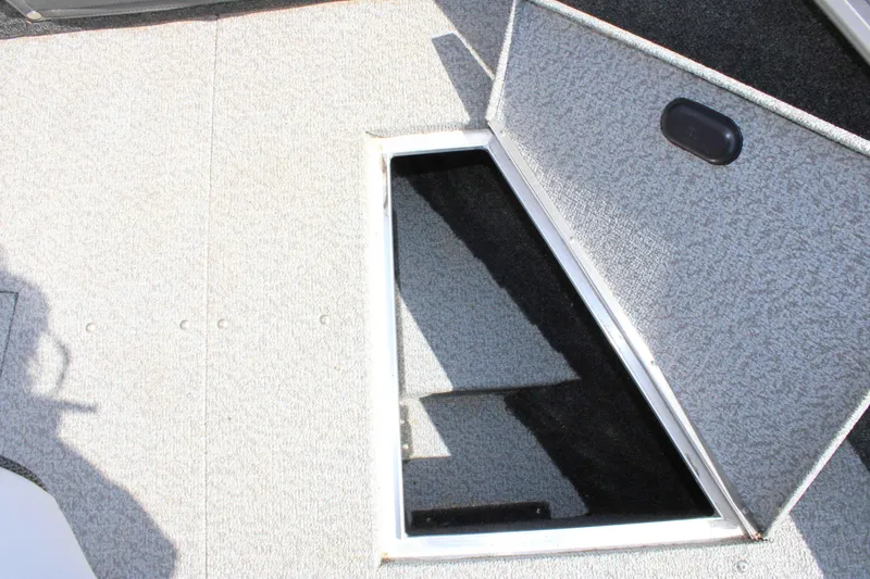 Slide: The Image of 2013 Lund 1675 Impact Sport boat interior storage compartment. - 13