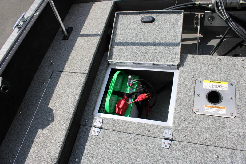 Slide: The Image of 2013 Lund 1675 Impact Sport boat battery compartment with open hatch. - 17