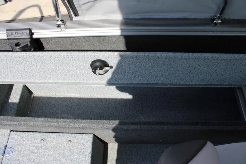 Slide: The Image of 2013 Lund 1675 Impact Sport boat interior with storage compartment and rod holder. - 19