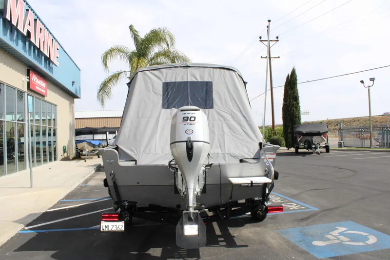 Slide: The Image of 2013 Lund 1675 Impact Sport boat with Honda 90 VTEC engine at a marine dealership. - 22