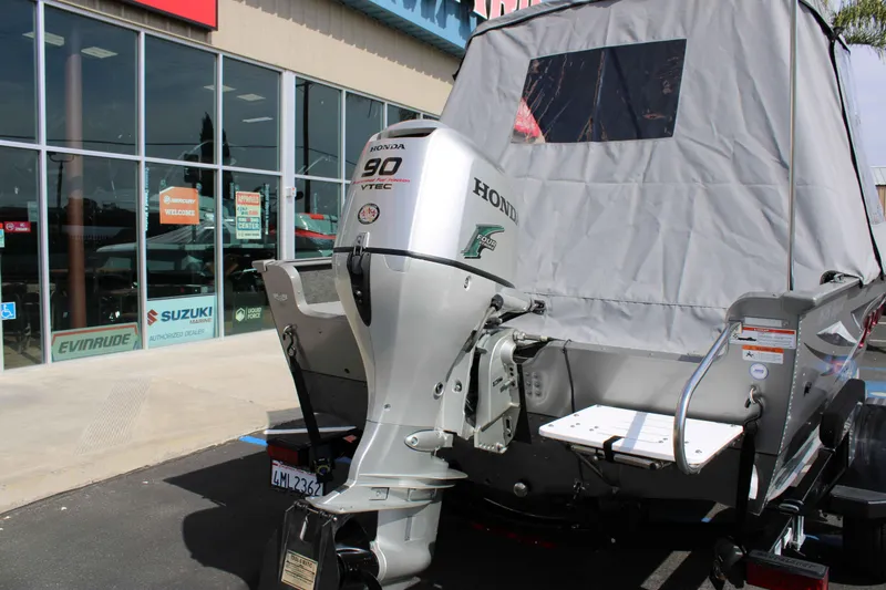 Slide: The Image of 2013 Lund 1675 Impact Sport boat with Honda 90 VTEC engine at dealership. - 23