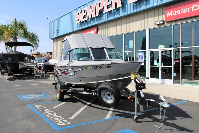 Slide: The Image of 2013 Lund 1675 Impact Sport boat on trailer outside dealership. - 3