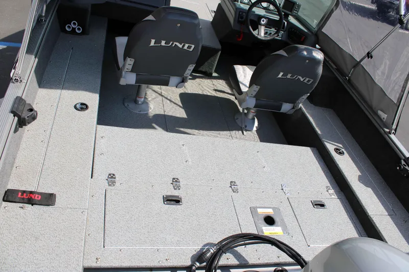 Slide: The Image of 2013 Lund 1675 Impact Sport boat interior with seating and steering console. - 6
