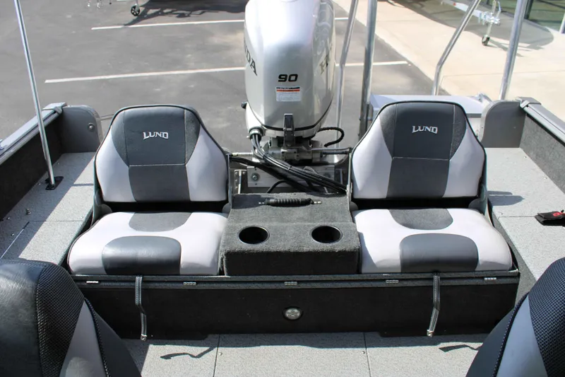 Slide: The Image of 2013 Lund 1675 Impact Sport boat interior with dual seats and Honda 90 engine. - 8