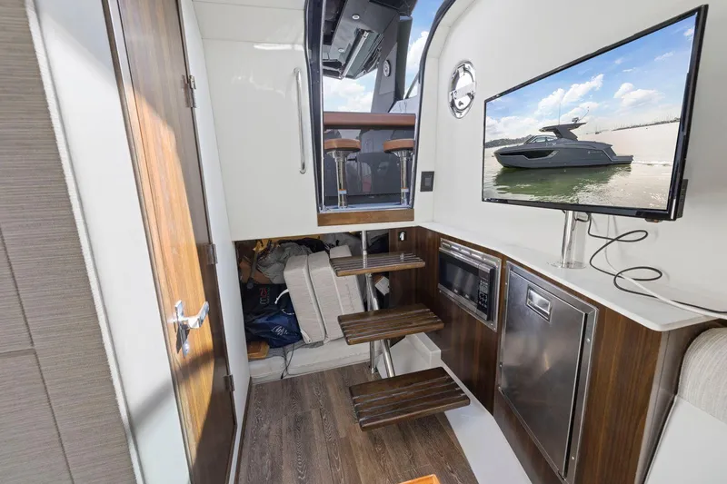 Slide: The Image of Interior of 2022 Cruisers Yachts 38 GLS South Beach IO with modern amenities and wooden accents. - 38