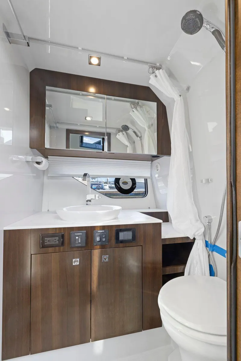 Slide: The Image of 2022 Cruisers Yachts 38 GLS South Beach IO bathroom with modern fixtures and wood accents. - 40